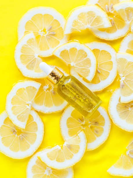 istock Essential oil, serum on textured background with yellow lemon slice 1447847788