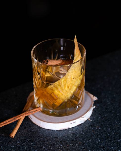 istock Whisky Cocktail with orange slice and cinnamon stick inside. 1447848061