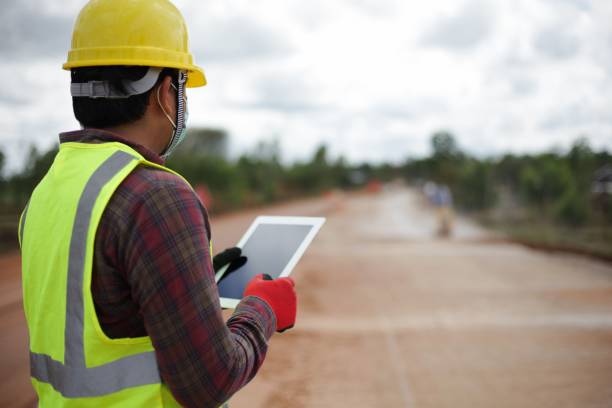 istock A male contractor wearing a helmet with a tablet is standing to inspect the work. 1447848201