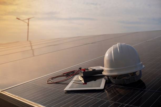 istock Engineer's helmet with a current measuring device placed on a solar panel in the evening sun 1447848207