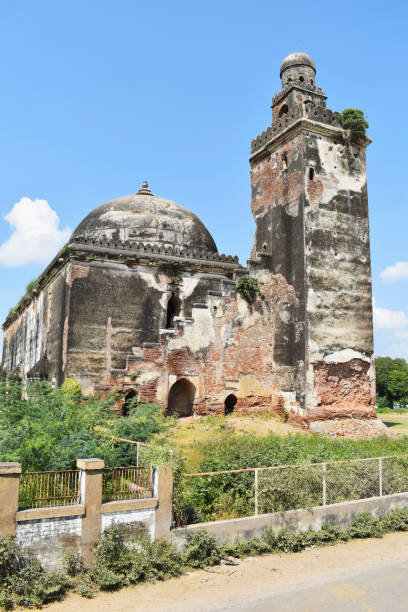 istock Alif Khan Masjid Dome and Minar, view from right, build in 1325 AD, brick structure, has 3 domes each of 100 square feet with echo effect, constructed by Alif Khan Bhukai, a childhood friend of Mahmud Begada at Dholka, Gujrat, India 1447850703
