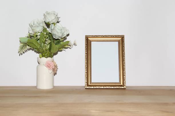 istock Wooden frame with copy space next to a roses bouquet in a vase 1447850862