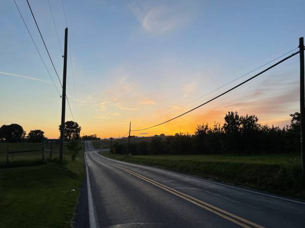 istock View of the sunset and empty asphalted road 1447852088