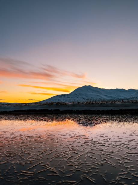 istock Sunset sky and mountains reflected on the lake water surface 1447855316