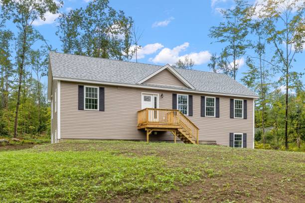 istock Grey modern construction of contemporary raised ranch surrounded by trees 1447859361