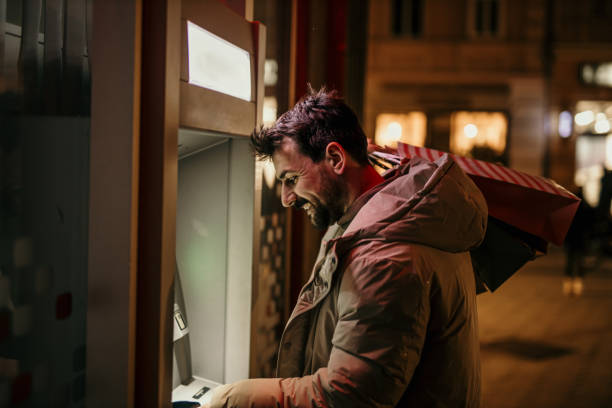 istock Withdrawing money from ATM 1447859408