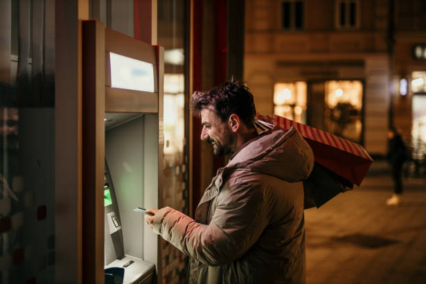 istock Withdrawing money from ATM 1447859412