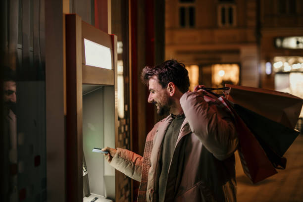 istock Withdrawing money from ATM 1447859481