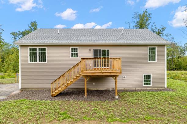istock Grey modern construction of contemporary raised ranch surrounded by trees 1447859542