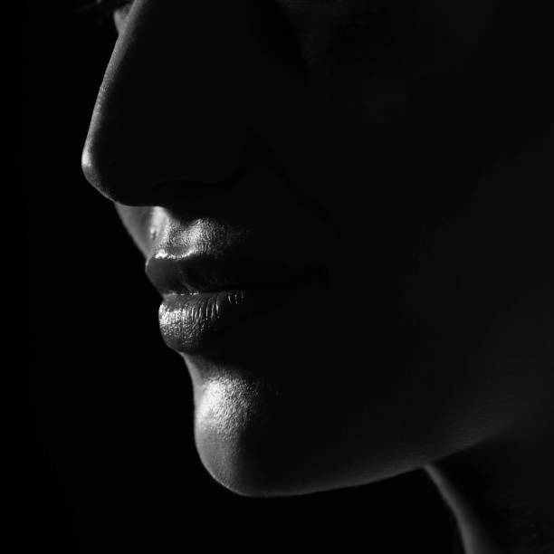 istock Part beautiful woman face silhouette covered in shadow 1447859726