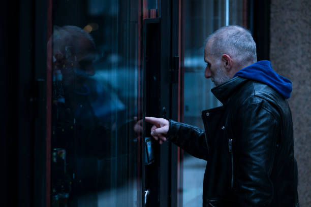 Adult man buying on automatic vending machine on street.