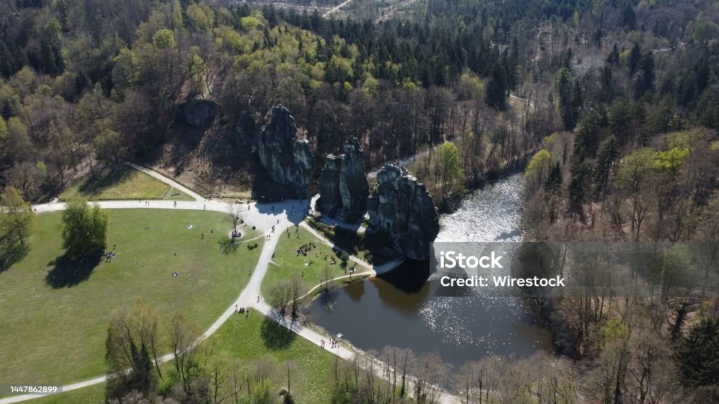 Aerial view of the Externsteine sandstone rock formation with greenery and a river on the right side An aerial view of the Externsteine sandstone rock formation surrounded by greenery and a river on the right side Externsteine Stock Photo