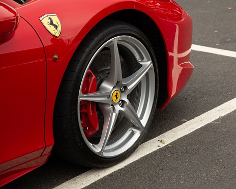 Thetford, United Kingdom – June 04, 2022: A close-up shot of the tire of the luxury Italian red Ferrari in the parking place