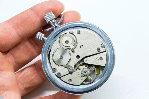 Movement of automatic mechanical wrist watch is behind transparent back case, close-up photo