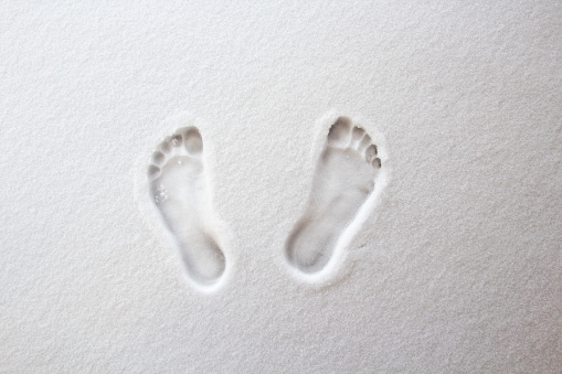 two bare foot on the fresh white snow