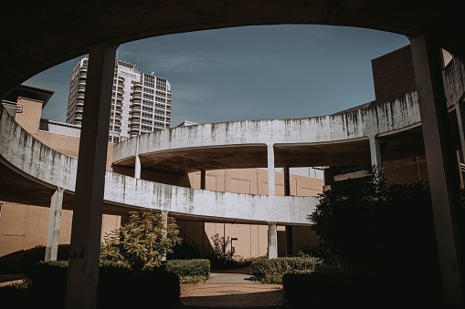 A spiral concrete car park ramp and building on background in Swindon town, Wiltshire, England