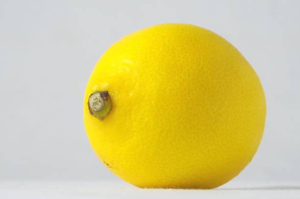 Lemon photographed up close. Sprinkled with water.