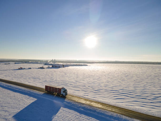 istock Lorry truck on the road surrounded by winter fields. 1447867648