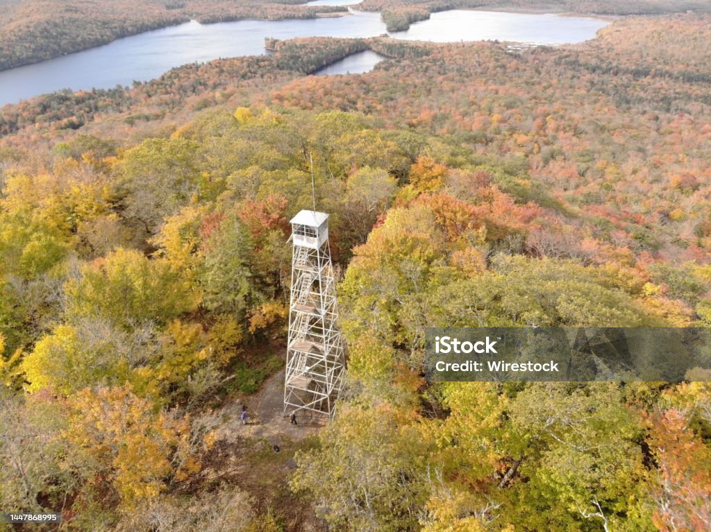 Aerial of Kane Mountain Fire Tower with autumn forest scape water near Fulton County, New York An aerial of Kane Mountain Fire Tower with autumn forest scape water near Fulton County, New York Aerial View Stock Photo