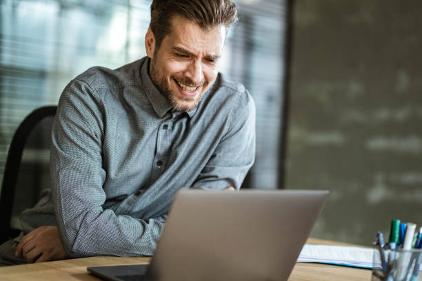 istock Businessman reading an e-mail on laptop in the office. 1447869959