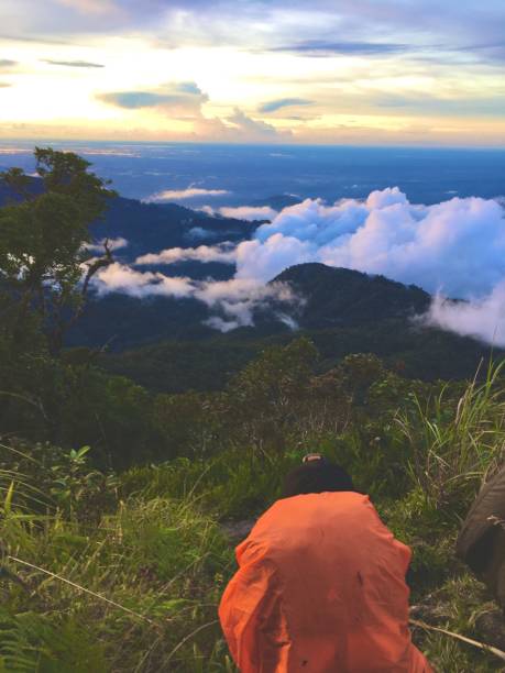 istock Young men having sunset and relaxing at mountain peak 1447873673