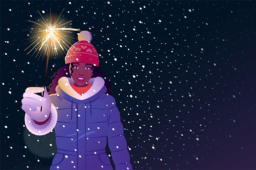 Young woman in warm clothes with a sparkler on a Christmas night