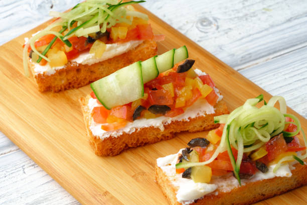 istock Delicious vegetable bruschetta slices on wooden board 1447875166
