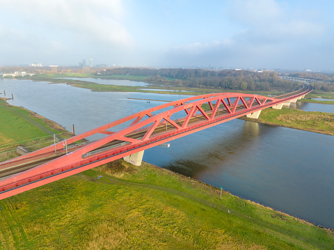 Hanzeboog train bridge over the river IJssel near the city of Zwolle in Overijssel, The Netherlands. Aerial drone point of view.
