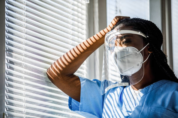 istock Copy space shot of nurse leaning against the window, taking a small break from work 1447876365