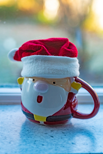 Generic Santa Claus mug on a kitchen windowsill.