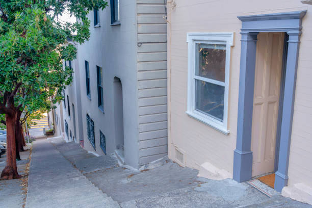 istock Steep sloped concrete side walk with steps in the middle in San Francisco, California 1447879302