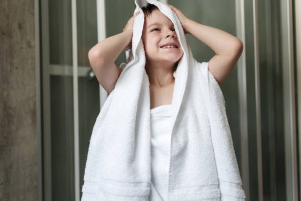 istock Happy boy drying himself with a towel after shower 1447879897