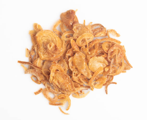 istock Crispy fried onion slices on a white background 1447880695