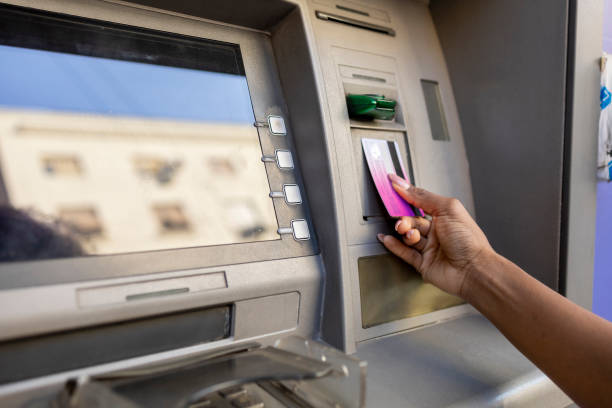 istock Female hand using credit card at ATM 1447881096