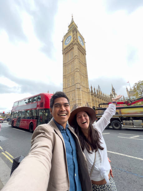 Diverse couple taking selfie in London