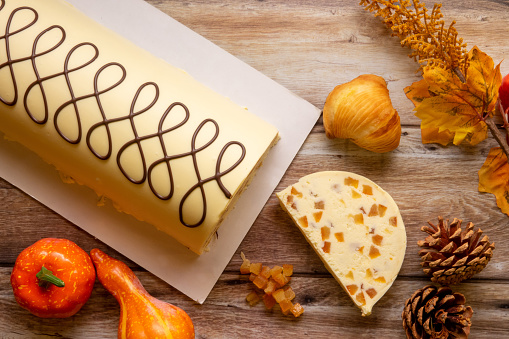 Artisan nougat with sfogliatella from above on wood with autumnal decorations