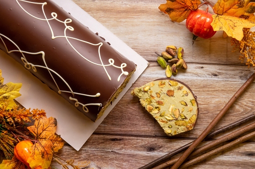 Handcrafted pistachio nougat from above on the wood with autumn decorations