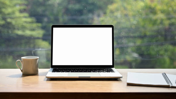 istock A laptop computer white screen mockup on the table against the window. coffee shop workplace 1447884182
