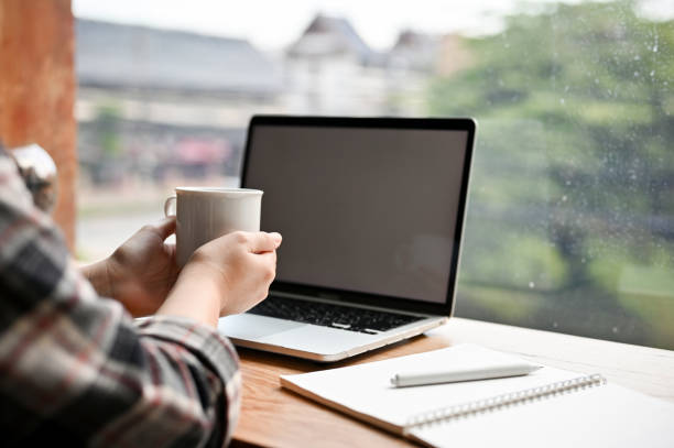 istock Female remote working at the coffee shop, sipping coffee while working on her tasks on laptop 1447884203