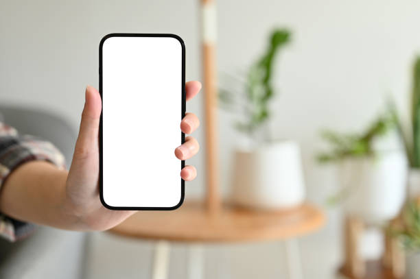 istock Close-up image, A female showing a smartphone white screen mockup over blurred background 1447884409