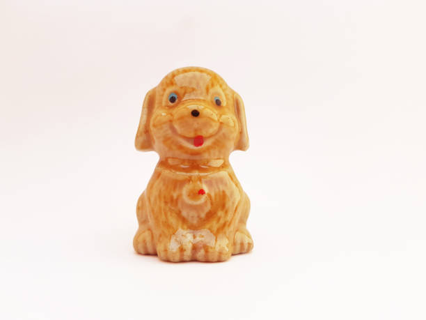 istock A ceramic craft with an old golden brown dog character on a white background 1447886067
