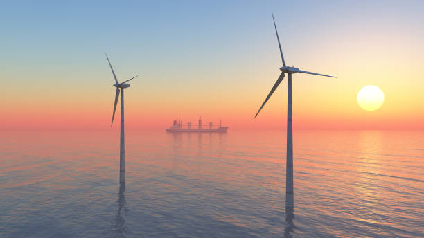 Aerogeneradores marinos y buque de carga al atardecer - foto de stock