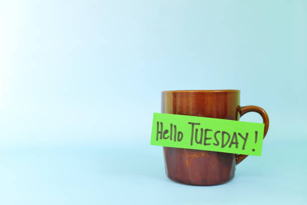 istock Welcome, hello and happy Tuesday concept. Selective focus of coffee cup with written message isolated in blue background. 1447888071