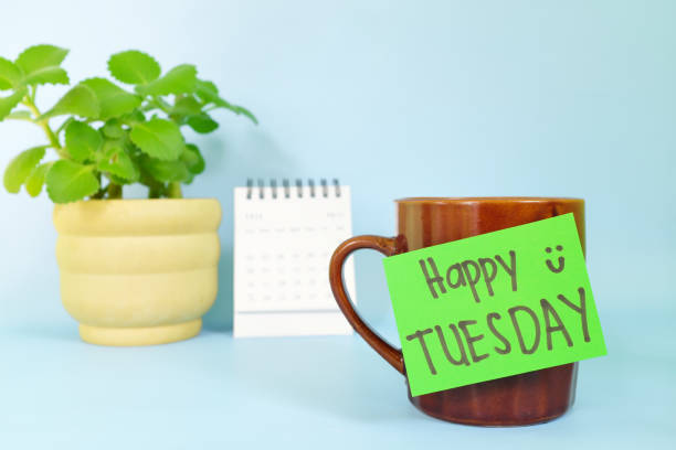 istock Welcome, hello and happy Tuesday concept. Selective focus of coffee cup with green paper note and written message. 1447888078