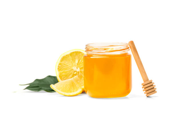 istock Honey with lemon on white background. 1447889510