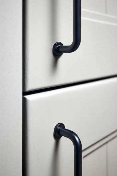 istock Grey moss solid ash wood painted cupboard cabinet doors modern interior with doorknob black handles, storage or wardrobe closed with metal handles vertical. 1447889741