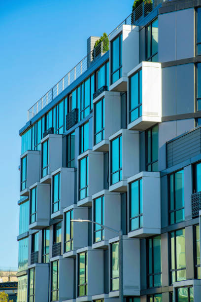 istock Decorative building facade with block style design and visible blue window exterior with sky background in late afternoon city 1447890848