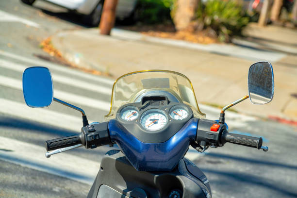 istock Blue scooter with side mirrors and visible speedometer parked in the shade in the downtown city or in the neighborhood 1447890970