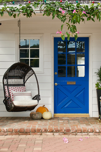 Lapis blue door on a white farmhouse style cottage
