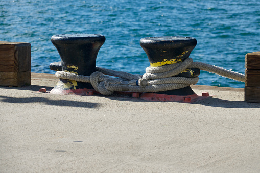 Closeup of vintage bollards quayside on the pier